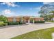 Charming home with double door entry, green bushes, well-designed landscaping, and a long driveway at 30703 San An Rd, San Antonio, FL 33576