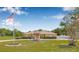 Spacious front yard with a fountain and meticulously manicured lawn, creating a welcoming curb appeal at 30703 San An Rd, San Antonio, FL 33576