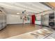 Spacious garage featuring epoxy floors, ample storage, utility sink, and laundry appliances at 30703 San An Rd, San Antonio, FL 33576