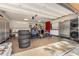 Well-organized garage space with storage cabinets, a washer/dryer unit, and various equipment for hobbies at 30703 San An Rd, San Antonio, FL 33576
