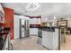 Well lit kitchen featuring stainless steel appliances, bar, and dark granite countertops at 30703 San An Rd, San Antonio, FL 33576