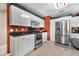 Bright kitchen with stainless steel appliances, white cabinets, and black countertops at 30703 San An Rd, San Antonio, FL 33576