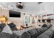 Relaxing living room with a large sofa, entertainment center, and adjacent breakfast bar at 30703 San An Rd, San Antonio, FL 33576