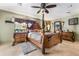 Ornate primary bedroom with a wooden four-poster bed and vintage furniture at 30703 San An Rd, San Antonio, FL 33576