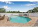Beautiful backyard pool with brick pavers, white fencing, and decorative columns perfect for outdoor entertaining at 30703 San An Rd, San Antonio, FL 33576