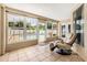 Inviting sun room with tiled floors, large windows overlooking the pool, and a massage chair for relaxation at 30703 San An Rd, San Antonio, FL 33576