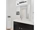 Modern bathroom features black vanity, white countertop, and a large mirror at 3100 W Paul Ave # 14, Tampa, FL 33611