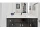 Modern bathroom boasts a black vanity with a white countertop and a large mirror at 3100 W Paul Ave # 14, Tampa, FL 33611