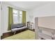 Bright, naturally lit bedroom with a futon, world map, and lofted bed at 3100 W Paul Ave # 14, Tampa, FL 33611