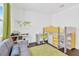 Bright bedroom with a gray sofa, lofted bed, shelves, and a fun world map at 3100 W Paul Ave # 14, Tampa, FL 33611