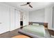 Relaxing bedroom with natural light, ceiling fan, and decorative wall with a door leading to an attached bathroom at 3100 W Paul Ave # 14, Tampa, FL 33611