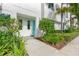 Inviting entryway with well-manicured landscaping and a bright blue front door, creating curb appeal at 3100 W Paul Ave # 14, Tampa, FL 33611