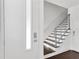 Bright entryway featuring a modern staircase with wooden treads and minimalist railing and an electronic door lock at 3100 W Paul Ave # 14, Tampa, FL 33611