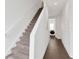 Hallway with carpeted stairs and laundry room features a modern washer and dryer at 3100 W Paul Ave # 14, Tampa, FL 33611