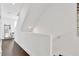 Upstairs hallway with hardwood floors and white walls leading to bedrooms at 3100 W Paul Ave # 14, Tampa, FL 33611