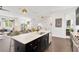 Modern kitchen with island, stainless steel appliances, and dark wood floors flowing into the open-concept living area at 3100 W Paul Ave # 14, Tampa, FL 33611