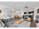 Bright, open-concept living space featuring a modern kitchen, comfortable seating, and a stylish dining area near the staircase at 3100 W Paul Ave # 14, Tampa, FL 33611
