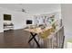 Open-concept living room with hardwood floors, a dining table, and ample seating, perfect for entertaining guests at 3100 W Paul Ave # 14, Tampa, FL 33611