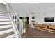 View of a staircase and open floor plan with a view of the kitchen and living room at 3100 W Paul Ave # 14, Tampa, FL 33611