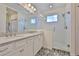 Elegant bathroom features a double vanity with a sleek countertop and a modern glass-enclosed shower at 314 Blackrock Ln, Apollo Beach, FL 33572