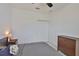 Simple bedroom with a ceiling fan, closet, dresser, and a nightstand with a lamp at 314 Blackrock Ln, Apollo Beach, FL 33572