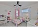 Bright bedroom boasts charming decor, a ceiling fan, and ample natural light from the window at 314 Blackrock Ln, Apollo Beach, FL 33572