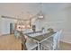 Elegant dining area with wood floors, stylish chandelier, and adjacent modern kitchen at 314 Blackrock Ln, Apollo Beach, FL 33572