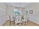 Charming dining room features wainscoting, wood floors, and a decorative chandelier at 314 Blackrock Ln, Apollo Beach, FL 33572