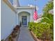 Charming entryway with an American flag, a wreath and well-manicured landscaping at 314 Blackrock Ln, Apollo Beach, FL 33572