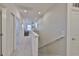 Upstairs hallway with neutral decor and great lighting leading to various rooms in the home at 314 Blackrock Ln, Apollo Beach, FL 33572