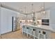 Stylish white kitchen offers a stainless refrigerator, quartz counters, and island seating at 314 Blackrock Ln, Apollo Beach, FL 33572