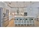 Modern white kitchen with stainless refrigerator, quartz counters, and a center island at 314 Blackrock Ln, Apollo Beach, FL 33572