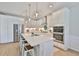 Lovely kitchen boasts stainless appliances, quartz counters, and an island with seating at 314 Blackrock Ln, Apollo Beach, FL 33572