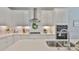 Clean white kitchen highlighting stainless appliances, sleek quartz counters, and ample cabinetry at 314 Blackrock Ln, Apollo Beach, FL 33572