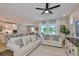 Open-concept living room features comfortable seating and views of the modern kitchen at 314 Blackrock Ln, Apollo Beach, FL 33572