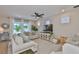 Bright living room featuring large windows, neutral colors, and a view of the private backyard at 314 Blackrock Ln, Apollo Beach, FL 33572