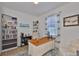 Comfortable home office with built-in shelving, desk, and a cozy armchair for reading at 314 Blackrock Ln, Apollo Beach, FL 33572