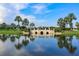 Picturesque bridge over a tranquil pond, reflecting the clear blue sky and surrounding greenery at 314 Blackrock Ln, Apollo Beach, FL 33572