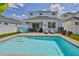 Backyard view of pool with brick pavers, outdoor seating area, and rear exterior of home at 314 Blackrock Ln, Apollo Beach, FL 33572