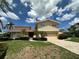 Well-manicured front yard with lush landscaping and a charming two-story home at 413 Midway Is, Clearwater Beach, FL 33767