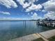 Calm waterfront view showing the intracoastal waterway with boats, blue skies, and fluffy white clouds at 413 Midway Is, Clearwater Beach, FL 33767