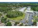 Aerial view of the community school, showcasing its facilities, parking area, and surrounding green spaces and neighborhoods at 4222 Glade Wood Loop, New Port Richey, FL 34655