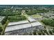 Aerial view of school grounds with sport fields, tennis courts, playground, and ample parking at 4222 Glade Wood Loop, New Port Richey, FL 34655