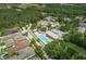 Aerial view features a community pool, cabana, and surrounding neighborhood, highlighting the amenities at 4222 Glade Wood Loop, New Port Richey, FL 34655