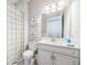 Clean bathroom with white vanity, toilet, and shower-tub combo at 4222 Glade Wood Loop, New Port Richey, FL 34655