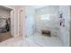 Beautiful glass shower with a bench seat and marble surround at 4222 Glade Wood Loop, New Port Richey, FL 34655