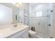 Bright bathroom featuring white cabinets, a marble countertop, and a glass-enclosed shower at 4222 Glade Wood Loop, New Port Richey, FL 34655