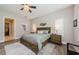 Spacious bedroom featuring wood floors, ceiling fan, and ensuite bath at 4222 Glade Wood Loop, New Port Richey, FL 34655