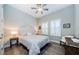 Inviting bedroom with wood floors, neutral colors, and natural light at 4222 Glade Wood Loop, New Port Richey, FL 34655
