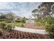 Doc Brittle Commons sign surrounded by trees and plants with neighborhood homes in the distance at 4222 Glade Wood Loop, New Port Richey, FL 34655